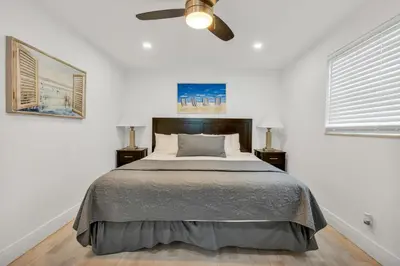 a bedroom with a bed and a ceiling fan at ULTRA peaceful 2 bedroom beach&boardwalk apartment in Hollywood