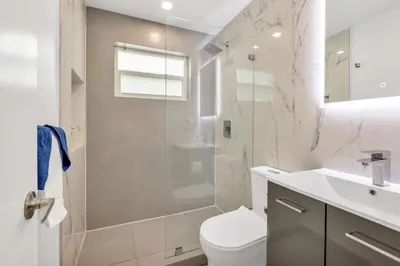 a bathroom with a shower and a toilet and a sink at ULTRA peaceful 2 bedroom beach&boardwalk apartment in Hollywood