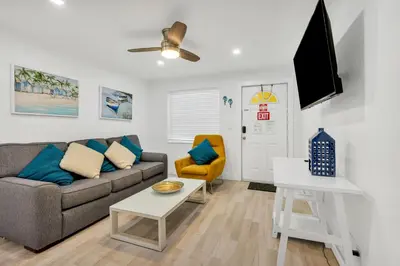 a living room with a couch and a table at ULTRA peaceful 2 bedroom beach&boardwalk apartment in Hollywood