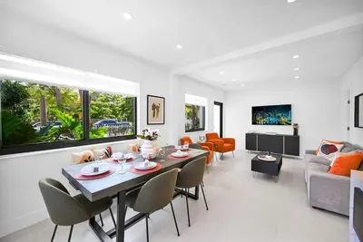 a white living room with a table and chairs at Stylish Oasis in Design District, Near Wynwood in Miami