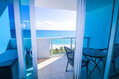 a room with a balcony with a view of the ocean at Castle 830 OceanView Balcony Studio, Pool, Tennis, Free Parking in Miami Beach