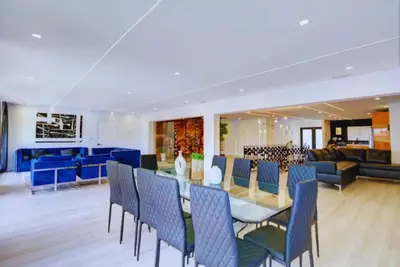a dining room and living room with a table and chairs at Club House 305 w PRIVATE NIGHTCLUB, Cinema, Game Room, Gym & Pool in Miami