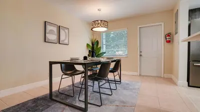 a dining room with a table and chairs at Serene 1BR Haven Fort Lauderdale in Fort Lauderdale