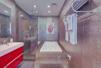 a bathroom with a tub and a sink and a shower at The Palms Villa with Cinema, Game Table, Pool, Jacuzzi , Giant Chess, 8 Beds in Miami