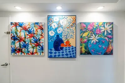 a group of four paintings on a wall at Welcome to our beach home! in Hollywood