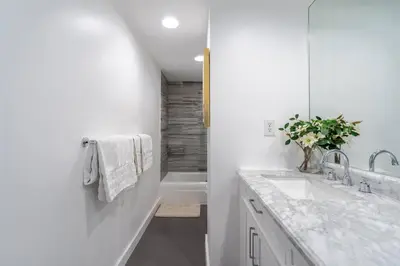 a white bathroom with a tub and a sink at Welcome to our beach home! in Hollywood