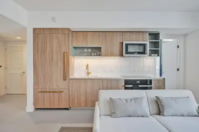 a living room with a couch and a kitchen at New 2-Bdrm Downtown Miami Apartment with Bay Vista in Miami