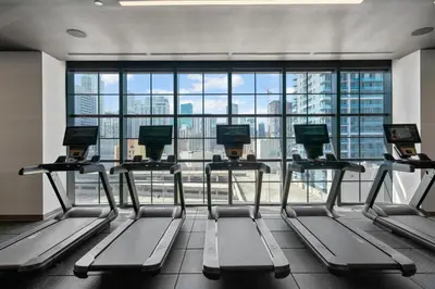 a gym with several tread machines in front of a large window at New 2-Bdrm Downtown Miami Apartment with Bay Vista in Miami