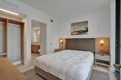 a bedroom with a large bed and a bathroom at New 2-Bdrm Downtown Miami Apartment with Bay Vista in Miami