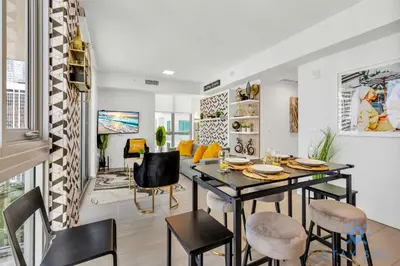 a living room with a dining room table and chairs at Beautiful Apartment with gym and amazing Pool in Miami