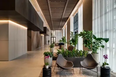 a hallway with chairs and potted plants in a building at New unit 28th Floor with Unbeatable Bayside Views in Miami