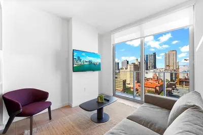 a living room with a couch and a large window at Luxury One-Bedroom w Top Amenities! in Miami