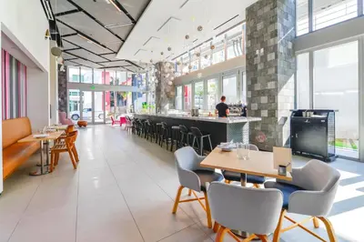 a restaurant with tables and chairs and a bar at Luxury One-Bedroom w Top Amenities! in Miami
