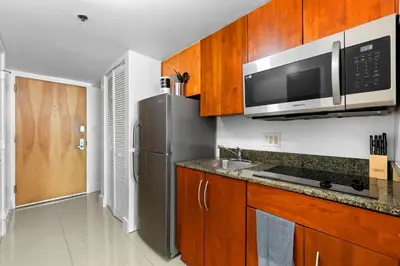 a kitchen with a stainless steel refrigerator and a microwave at Beautiful Condo w Breathtaking Views! in Miami