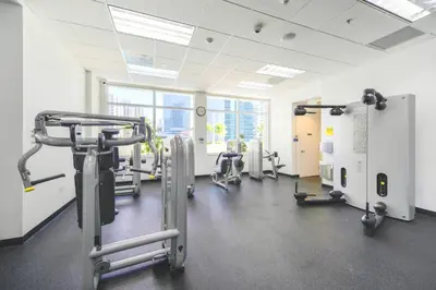a gym with treadmills and machines in a room at Beautiful Condo w Breathtaking Views! in Miami