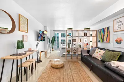a living room with a black couch and a table at Beautiful Condo w Breathtaking Views! in Miami