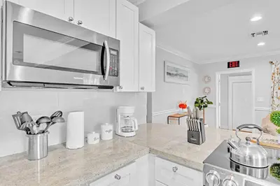 a kitchen with a stainless steel microwave above a counter at 5 Minutes to Ocean & Casino's - Large Backyard in Hollywood