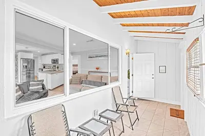 a living room with chairs and a large mirror at 5 Minutes to Ocean & Casino's - Large Backyard in Hollywood