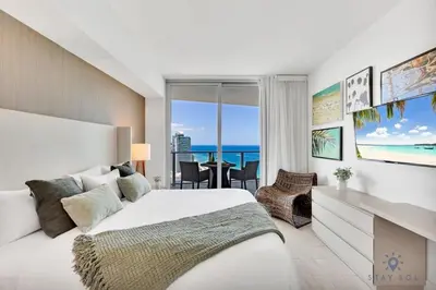 a bedroom with a bed and a view of the ocean at Seaside Elegance 1BR Retreat Stunning View in Hollywood