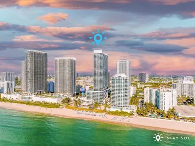 a view of a city with a beach and buildings at Seaside Elegance 1BR Retreat Stunning View in Hollywood