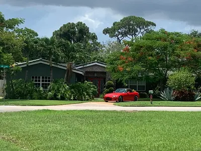 a red car parked in front of a house at Wilton Manors A Mens Oasis in Fort Lauderdale