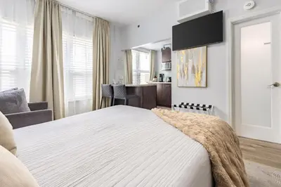 a bedroom with a large bed and a living room at Luxe ocean drive condo in miami south beach in Miami Beach