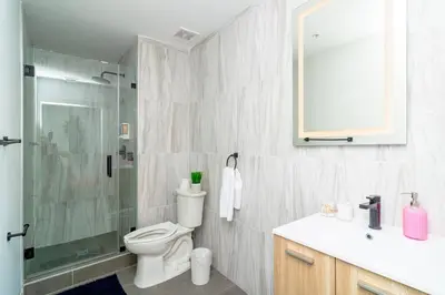 a bathroom with a toilet and a shower and a sink at Cozy Miami 2BR Oasis Near Brickell, Calle Ocho & Marlins Stadium in Miami