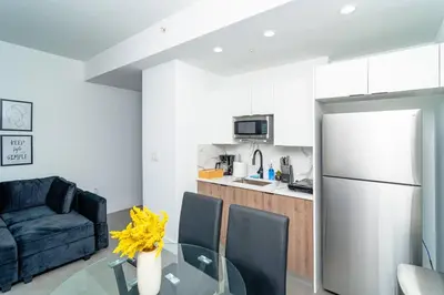 a kitchen with a glass table and a refrigerator at Central Miami 1BR Suite Close to Beach & Downtown in Miami