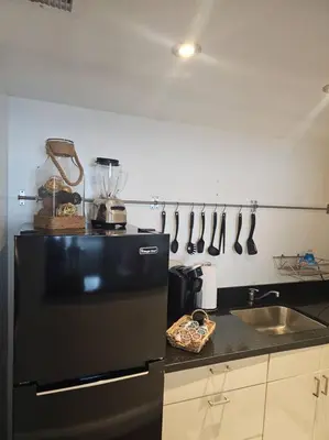 a kitchen with a black refrigerator and a sink at Great 1BedRoom RENOVATED 1 minute from the BEACH in Miami Beach