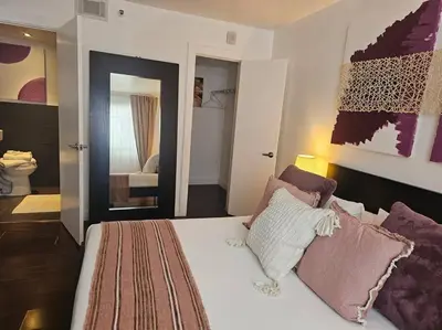 a bedroom with a large white bed with pillows at Great 1BedRoom RENOVATED 1 minute from the BEACH in Miami Beach