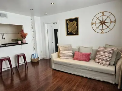 a living room with a couch with pillows on it at Great 1BedRoom RENOVATED 1 minute from the BEACH in Miami Beach