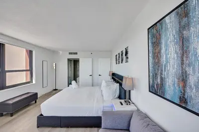 a bedroom with a large bed and a couch at Luxury Ocean View Condo with Beach Service 1521 in Miami Beach