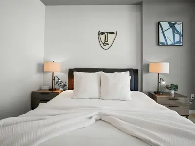 a bedroom with a large white bed with two night stands at Luxury & Modern Condo in Design District with Pool in Miami