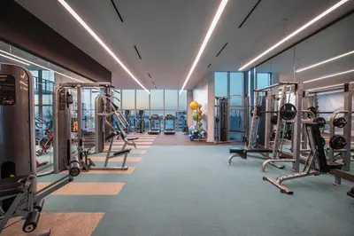 a gym with treadmills and machines in a building at Luxury & Modern Condo in Design District with Pool in Miami