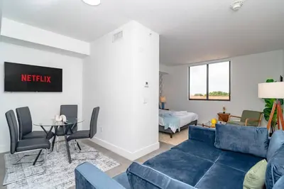 a living room with a blue couch and a table at Cozy and Comfortable 1BR Near Calle Ocho and Brickell in Miami
