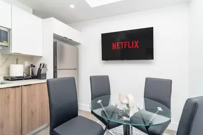 a dining room with a glass table and chairs at Cozy and Comfortable 1BR Near Calle Ocho and Brickell in Miami