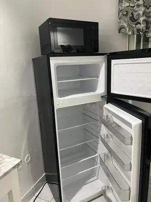 a refrigerator with a microwave on top of it at Private Studio in West Hialeah in Hialeah