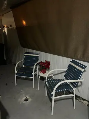 two blue and white chairs and a table with flowers at Private Studio in West Hialeah in Hialeah