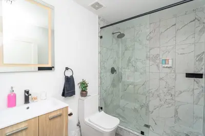 a bathroom with a shower with a toilet and a sink at Central 1BR in Miami with King Bed Near Wynwood and Marlins Park in Miami