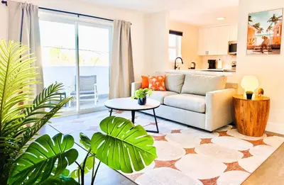 a living room with a couch and a table at Homey Haven in Vibrant South Beach in Miami Beach