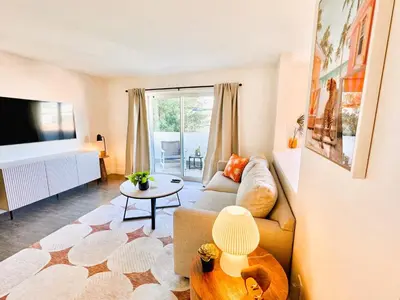 a living room with a couch and a table at Homey Haven in Vibrant South Beach in Miami Beach