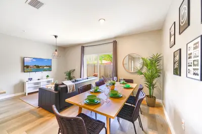 a dining room and living room with a table and chairs at Spacious 3BR Townhouse with Free Parking Included! in Miami