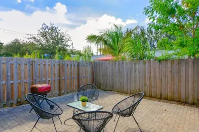 a patio with two chairs and a table and a fence at Spacious 3BR Townhouse with Free Parking Included! in Miami