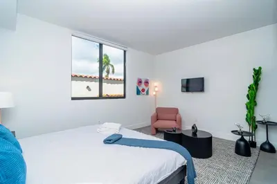a bedroom with a bed and a chair and a window at Beautiful 1BR in Little Havana Close with King Bed Near Brickell & Marlins Park in Miami