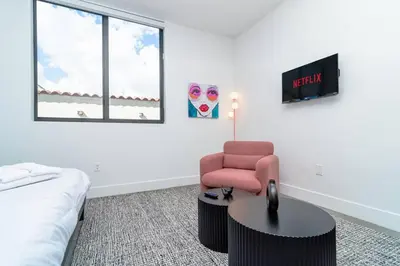 a bedroom with a bed and a chair and a table at Beautiful 1BR in Little Havana Close with King Bed Near Brickell & Marlins Park in Miami