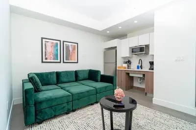 a living room with a green couch and a table at Relaxing 1BR in Miami Close to Brickell and South Beach in Miami
