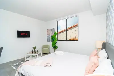 a white bedroom with a bed and a window at Centrally Located 1BR with King Bed Near Brickell, Airport Downtown and Wynwood in Miami