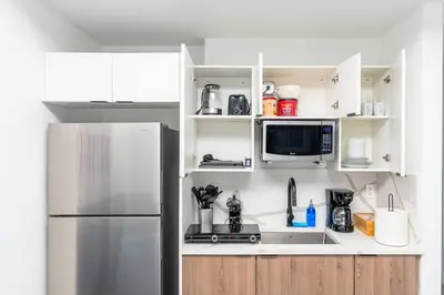 a kitchen with a refrigerator and a microwave at Centrally Located 1BR with King Bed Near Brickell, Airport Downtown and Wynwood in Miami
