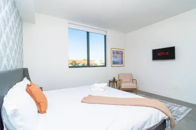 a white bedroom with a bed and a window at Well Located 1BR with King Bed, Laundry and Parking Option Near Brickell and Marlins Park in Miami