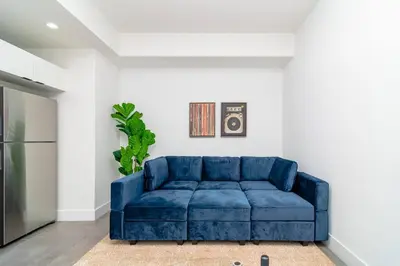 a blue couch sitting in a living room at Well Located 1BR with King Bed, Laundry and Parking Option Near Brickell and Marlins Park in Miami